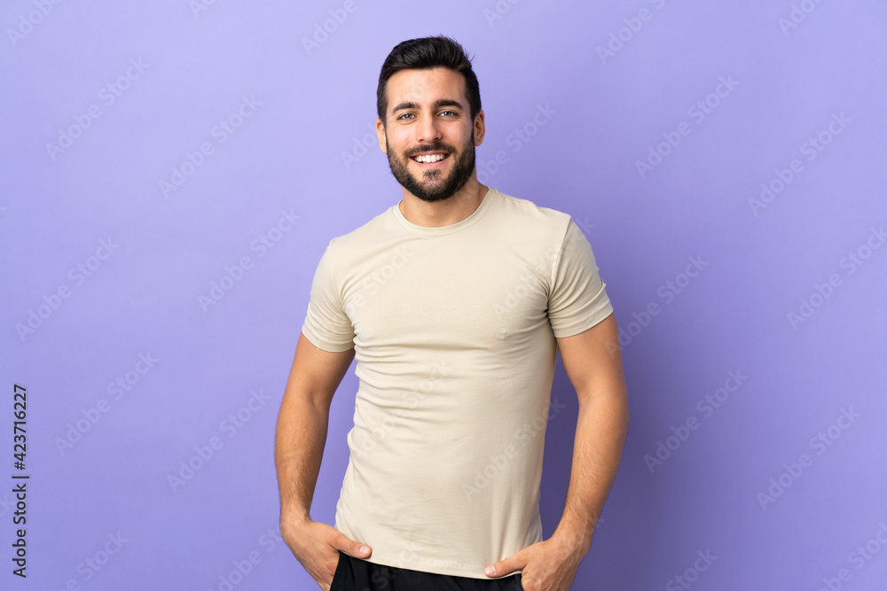 Young handsome man with beard over isolated background laughing Young handsome man with beard over isolated background laughing