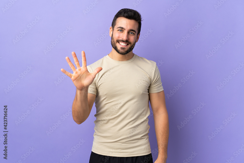 Young handsome man with beard over isolated background counting five with fingers Young handsome man with beard over isolated background counting five with fingers