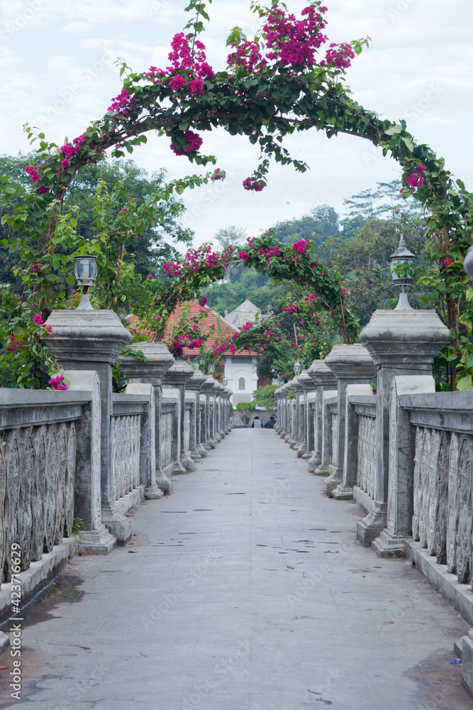 empty passage with stone arches decorated with flowers and traditional asian patterns