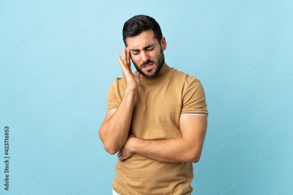 Fototapeta premium Young handsome man with beard over isolated background with headache