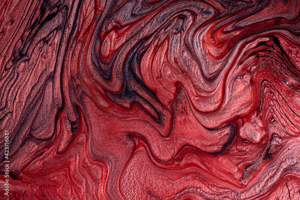 Textured stains of liquid nail polish,fluid art technique.Red color.Shimmer marble background