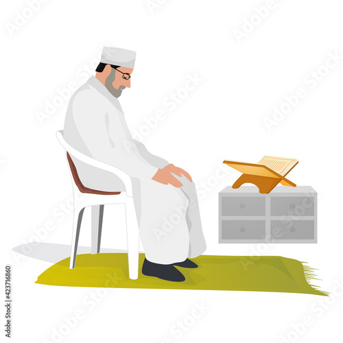 Elder Muslim man praying at home sitting on a chair