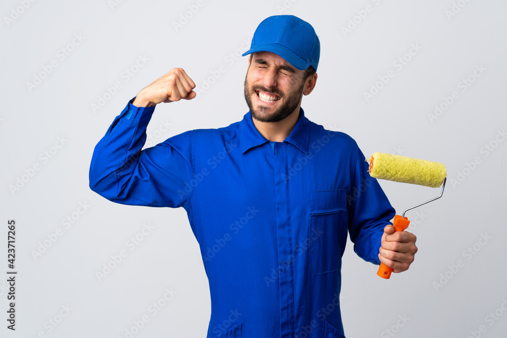 Painter man holding a paint roller isolated on white background doing strong gesture