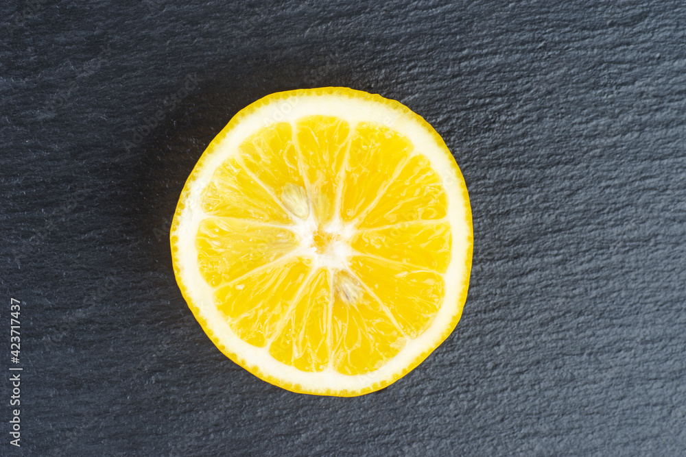 Piece of lemon on a black background Piece of lemon on a black background