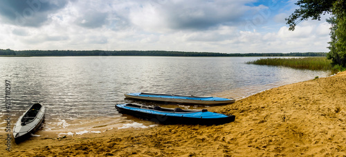 a three kayaks on the beach of Ostriv'yanske lake of Shatskyi Lakes group, Shatsk National Natural Park, Volyn region of Western Ukraine