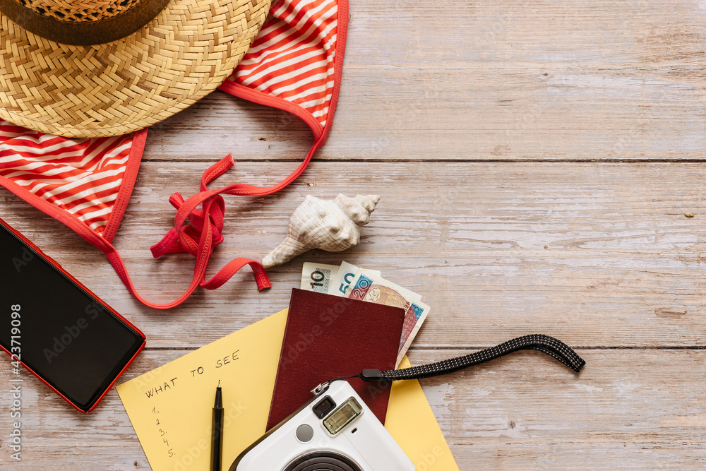 Travel concept banner flat lay.Items for summer vacation: passport,bikini,hat,money,smartphone,camera copy space.Top view holiday concept.Planning fun trip by sea.Travel accessories and bucket list