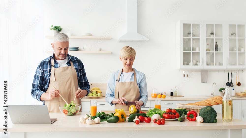 Adult couple prepare food together for family dinner