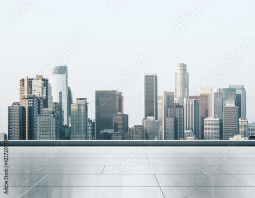Empty concrete rooftop on the background of a beautiful Los Angeles skyline at sunset, mock up