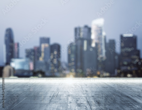 Empty dirty concrete rooftop on blurry background of a beautiful Los Angeles skyline at night, mock up © Pixels Hunter