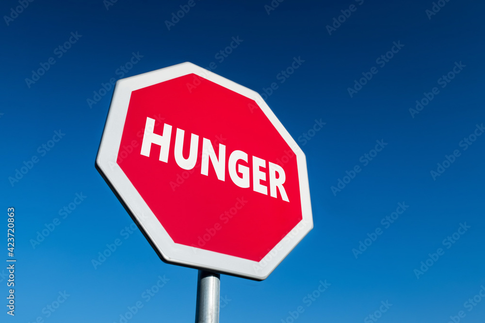 Stop traffic sign with HUNGER text to prevent the famine situation in poor parts of world Stop traffic sign with HUNGER text to prevent the famine situation in poor parts of world