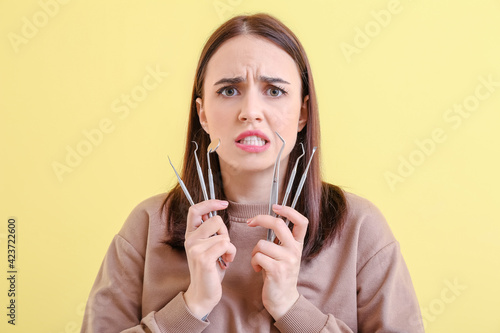 Scared young woman with den...