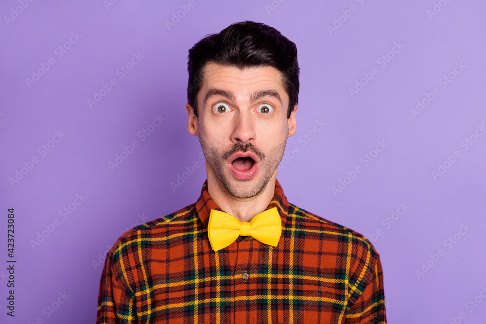 Portrait of attractive amazed stunned funky guy wearing checked shirt opened mouth isolated over violet purple color background Portrait of attractive amazed stunned funky guy wearing checked shirt opened mouth isolated over violet purple color background