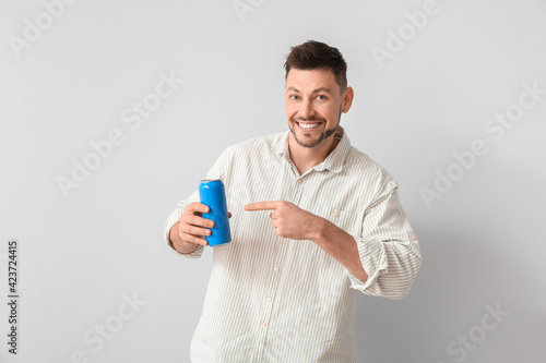 Handsome man with soda on l...