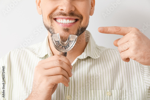 Man with dental tool for ma...