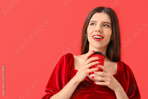 Young woman with beautiful manicure and coffee on color background