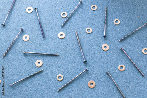 Repair. Screws and washers on the desktop. The concept of a repair shop.