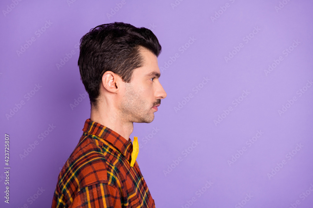Profile photo of calm serious strict guy look empty space wear bow tie checkered shirt isolated purple background Profile photo of calm serious strict guy look empty space wear bow tie checkered shirt isolated purple background