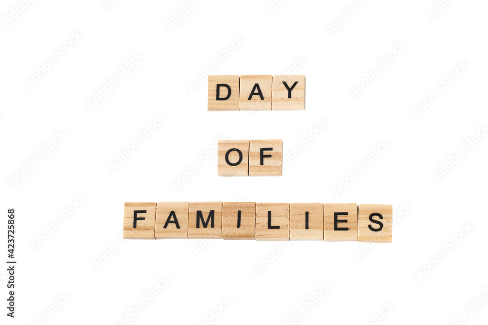 Top view of word day of familes made of square wooden tiles with the English alphabet scattered on a white background with space for text. The concept of thinking development, grammar. Top view of word day of familes made of square wooden tiles with the English alphabet scattered on a white background with space for text. The concept of thinking development, grammar.