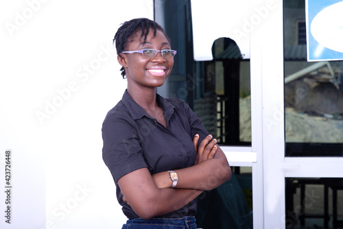 young businesswoman crossing her arms while smiling.