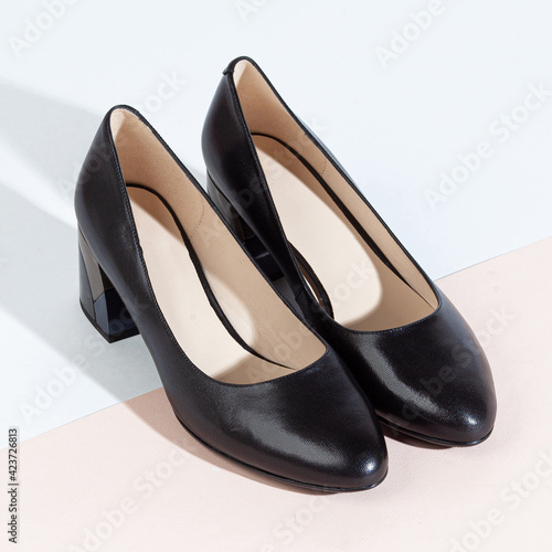 Woman shoes with long shadow on white background
