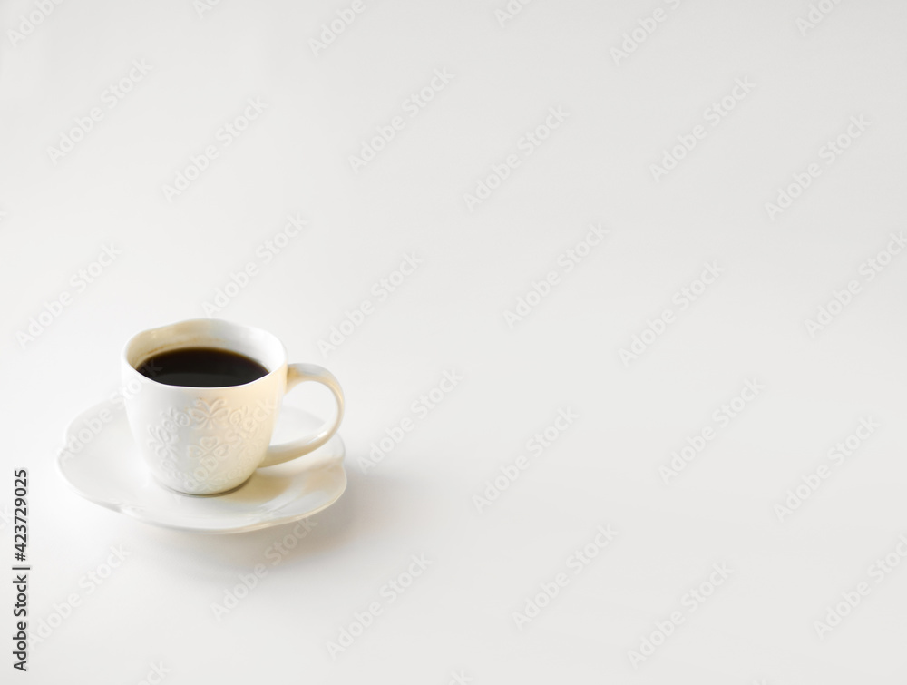 Drunk cup of strong coffee with coffee spent grounds on saucer with spoon against white background, top view with place for text Drunk cup of strong coffee with coffee spent grounds on saucer with spoon against white background, top view with place for text