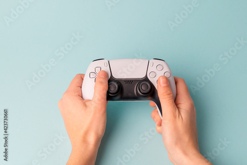 Videogame console wireless gamepad. Blue background. Minimal style. Modern leisure at home.  photo