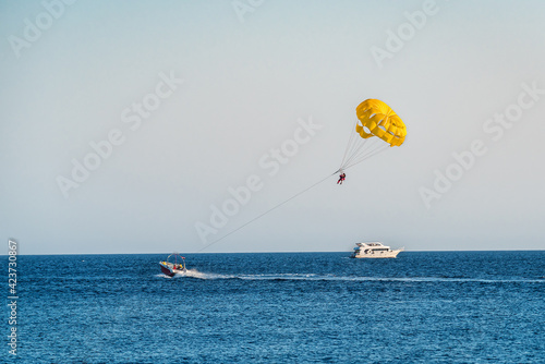 yellow parasailing over the sea