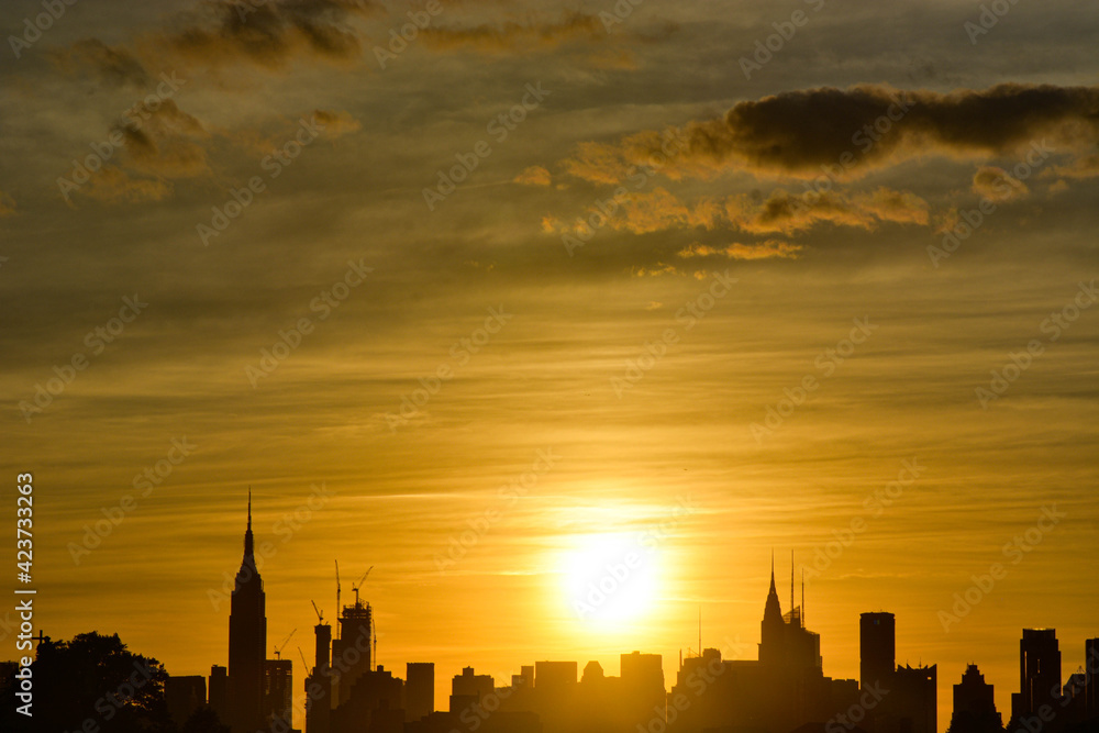 New York City silhouette skyline with striking sunset sky 