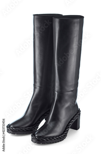 Beautiful women's leather boots with a high top, sole decorated with braided leather, low heel, isolated on a white background.