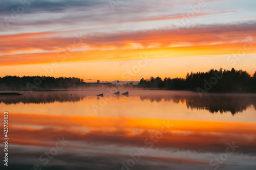 Wallpaper Mural Colorful sunset over the Lielais Ansis lake in Latvia. Sunset reflections in the water over the wakeboard park Torontodigital.ca