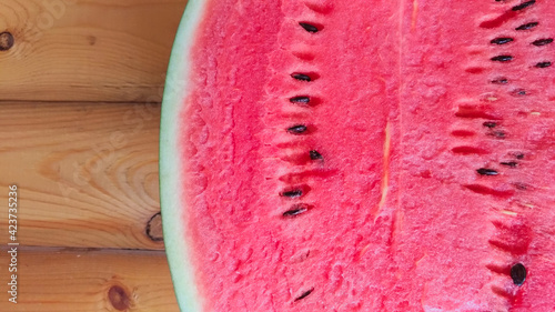Watermelon on wooden background. Top view. Summer illustration. Space for text.