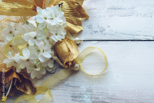 golden lilies ribbon and beads with hydrangea flowers photo