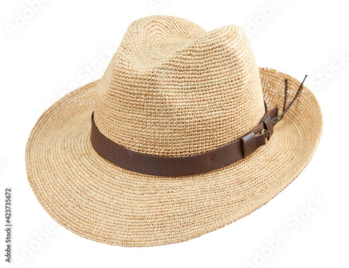 Beautiful wide-brimmed wicker hat fedora woven from straw, isolated on a white background. Beachwear and hats.