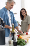 Couple cooking together in their kitchen at home.