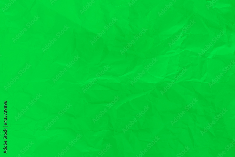 Green wrinkled paper background from general discarded paper.