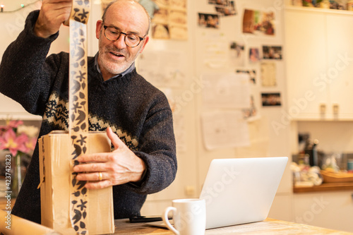 Man taping up parcel for delivery