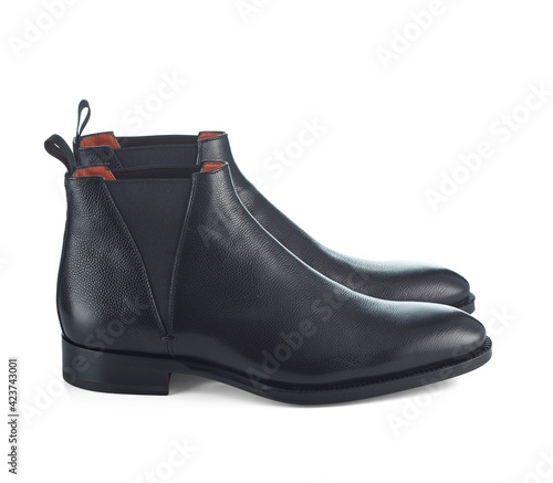 Autumn Chelsea boots made of beautiful leather with low heels, highlighted on a white background with a light shadow. Side view.