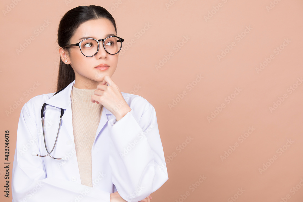 Young female doctor posing isolated on brown background Young female doctor posing isolated on brown background