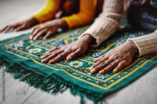Hands of muslim people praying during islamic religious prayer