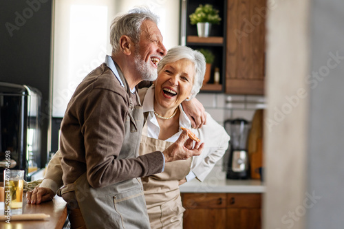 Fotografie Senior happy couple in love smiling in kitchen