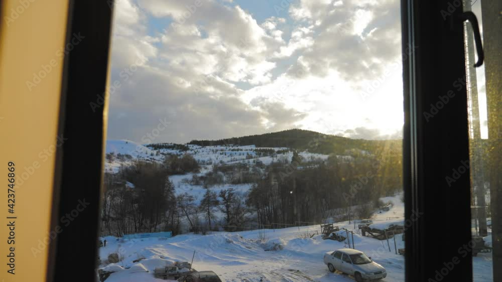 Snow landscape view through the window. View from the window to the snow-covered mountain. Beautiful winter landscape. Trees in the snow. Frosty winter morning. Snow landscape view through the window. View from the window to the snow-covered mountain. Beautiful winter landscape. Trees in the snow. Frosty winter morning.