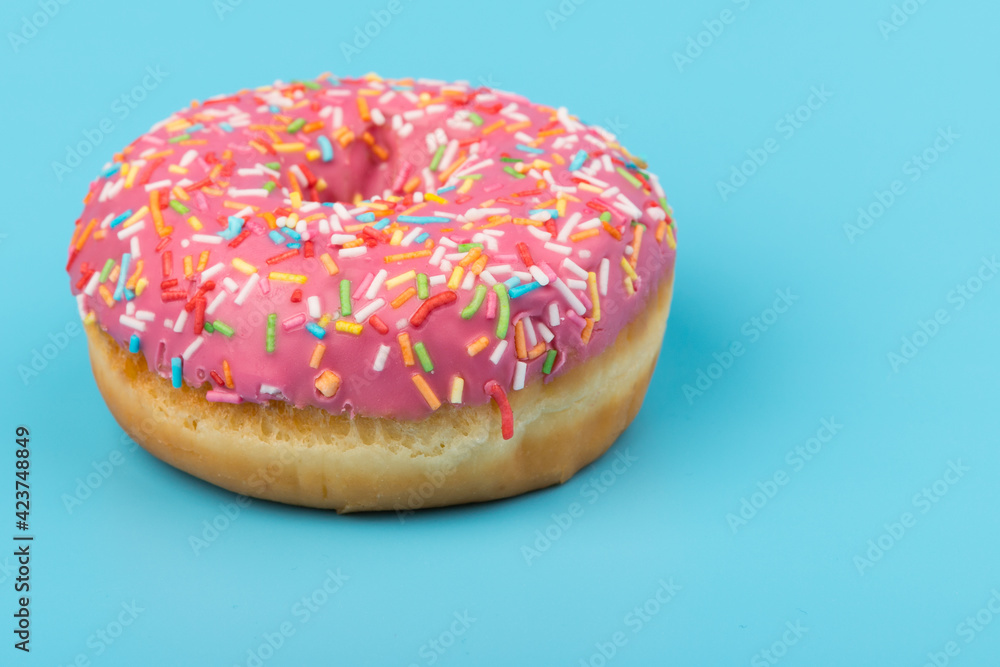 Fresh made Donuts isolated on blue background. Doughnuts are traditional sweet pastries. Copy space for text. Fresh made Donuts isolated on blue background. Doughnuts are traditional sweet pastries. Copy space for text.