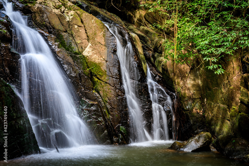 waterfall in the forest or motion of water at brook of water fall. with tree leaf and stone rock. at Spun or Span Nan province, Thailand, Asia.