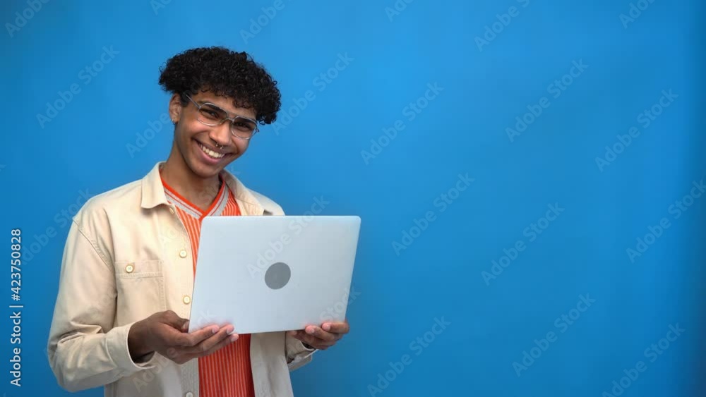 happy african american man holding laptop isolated on blue happy african american man holding laptop isolated on blue