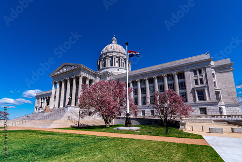 Missouri State Capitol with pink magnolia tree flowers in spring that houses General Assembly and executive branch of the government in Jefferson City