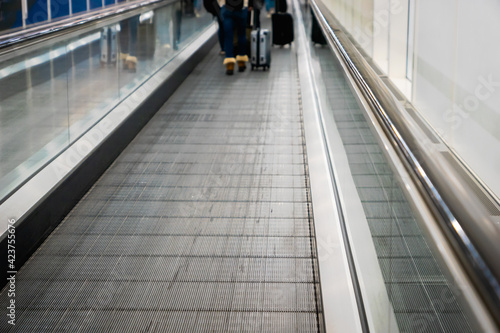 moving walkway, travelator, in airport terminal walkway for vacation travel abroad. concept of travel around world, tourism © uskarp2