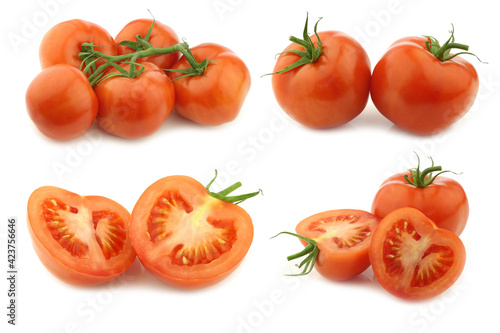 fresh tomatoes on the vine and some cut ones on a white background