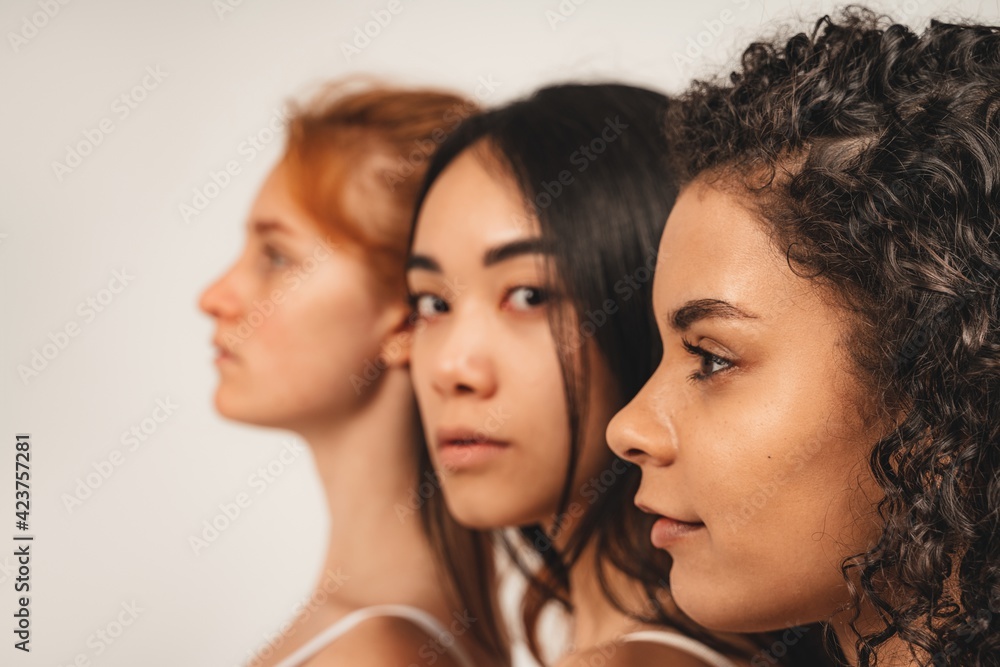 Photo of optimistic young women, face in profile with no make up. Concept natural beauty and girl power