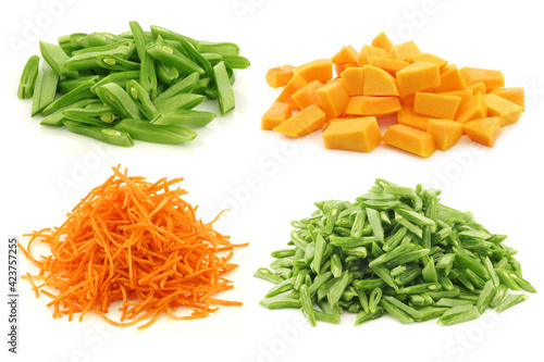 Cut string beans, butternut pumpkin and julienne cut carrots on a white background