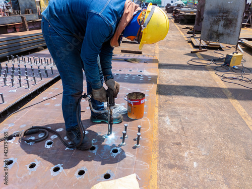 Принти на полотні Welder is using a Stud Welding Machine to weld stud bolt on steel plate, at industrial factory
